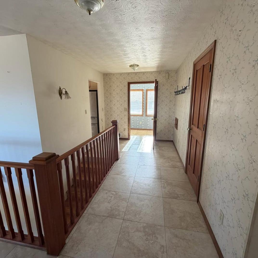 Upstairs hallway with railing before refresh